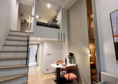 Modern living area with a loft and staircase