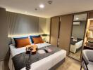 Modern bedroom with double bed, guitar, and wardrobe