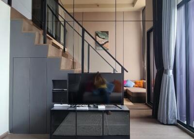 Modern living room with mezzanine and wall-mounted TV