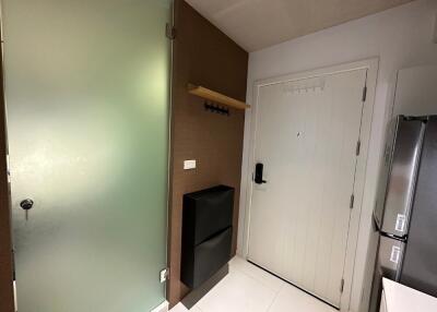 Modern apartment entryway with frosted glass door and white main door