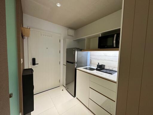 Modern kitchen with white cabinets and stainless steel appliances