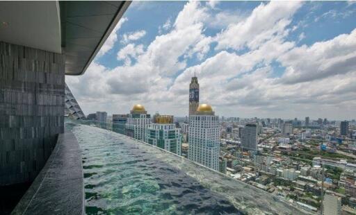 Rooftop view with infinity pool and cityscape