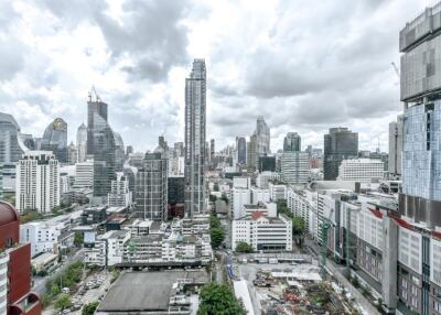 Aerial view of city buildings with cloudy sky