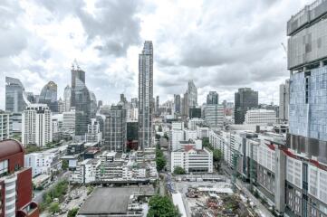 Aerial view of city buildings with cloudy sky