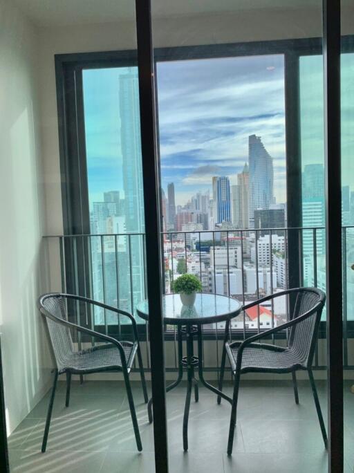 City view from balcony with two chairs and table