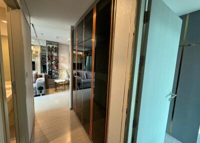 Well-lit hallway leading to a living space in an apartment