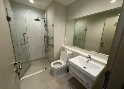 Modern bathroom with glass shower enclosure and floating sink