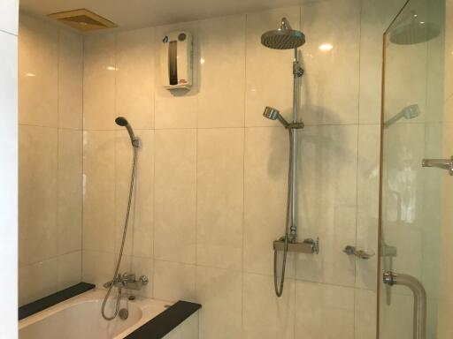 Modern bathroom with shower, bathtub, and water heater