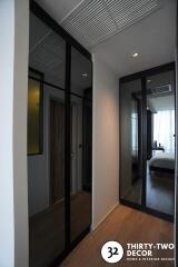 Modern bedroom with large mirrored wardrobe and wooden flooring