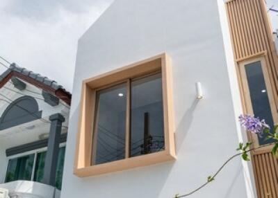 Modern white facade of a two-story house with large windows