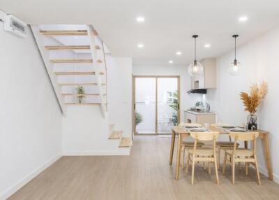 Modern dining area with wooden furniture and staircase