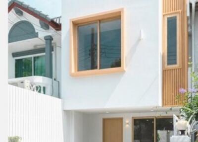 Facade of a modern house with a small vintage car parked outside