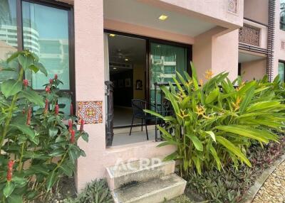 Exterior view of a building with plants and access to a patio