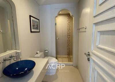 Modern bathroom with a blue sink and shower area