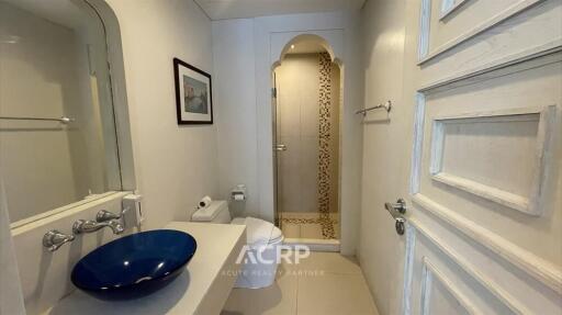 Modern bathroom with a blue sink and shower area