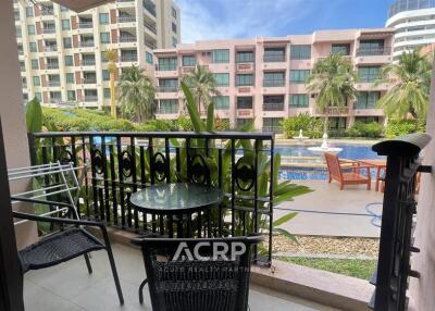 Balcony with outdoor furniture overlooking a pool area