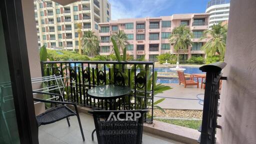 Balcony with outdoor furniture overlooking a pool area