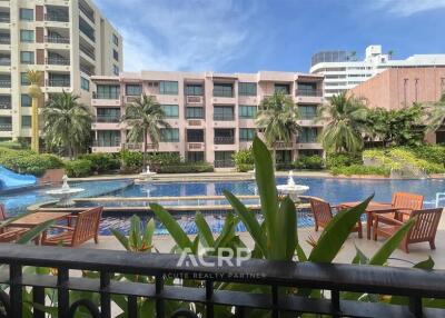 Exterior view of residential buildings with pool and outdoor seating