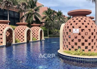 Outdoor pool area with unique pottery-like structures