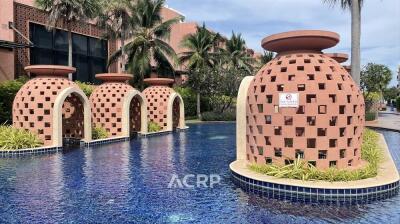 Outdoor pool area with unique pottery-like structures