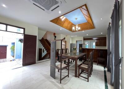 Spacious dining room with wooden furniture and unique ceiling design