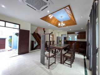 Spacious dining room with wooden furniture and unique ceiling design