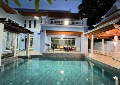 Outdoor view of a house with swimming pool