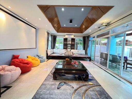 Spacious living room with modern decor and large windows