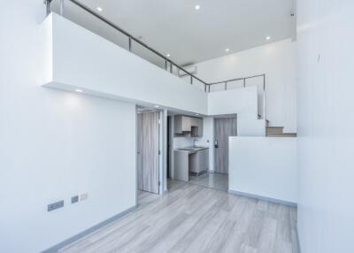 Modern duplex living area with open loft and kitchen