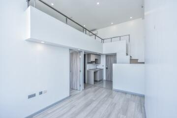 Modern duplex living area with open loft and kitchen