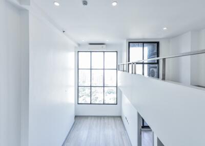 Modern loft-style living area with large windows