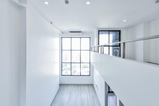 Modern loft-style living area with large windows