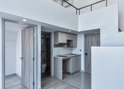 Modern kitchen with adjacent balcony and bathroom