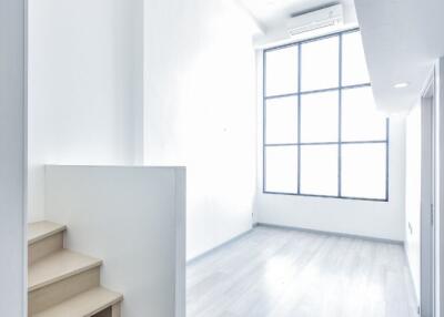 Bright and modern main living area with open space and staircase