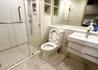 modern bathroom with glass-enclosed shower and white fixtures