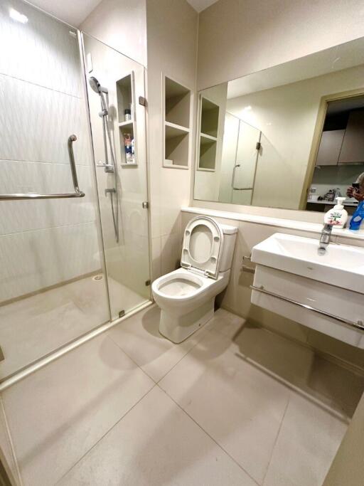 modern bathroom with glass-enclosed shower and white fixtures