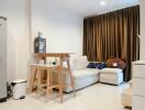 Modern living room with a white sofa, wooden table, stools, and floor-length curtains