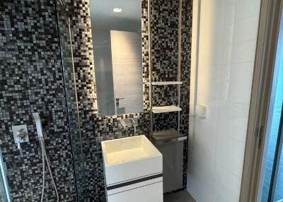 Modern bathroom with glass shower and mosaic tiles