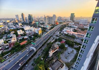 High-rise city view with roads and buildings at sunset