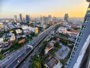 High-rise city view with roads and buildings at sunset