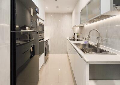 Modern kitchen with white cabinetry and stainless steel appliances