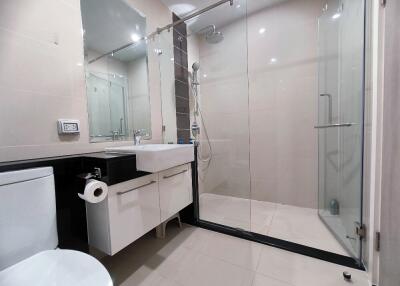 Modern bathroom with glass shower and white fixtures