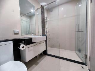 Modern bathroom with glass shower and white fixtures