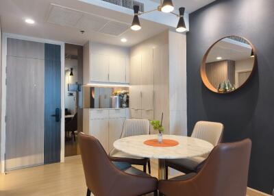 Modern dining area with round table and four chairs