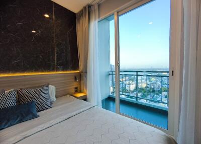 Modern bedroom with balcony and city view