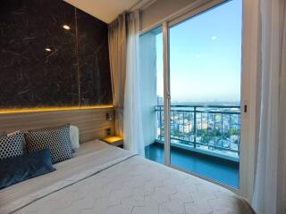 Modern bedroom with balcony and city view