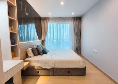 Modern bedroom with large window and elegant furnishings