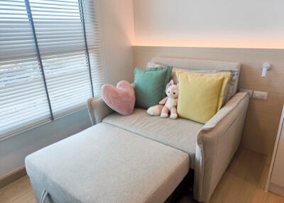 Cozy bedroom with plush toys on a small sofa bed