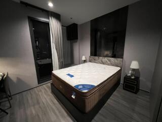 Modern bedroom with a large bed, bedside tables, and lamps