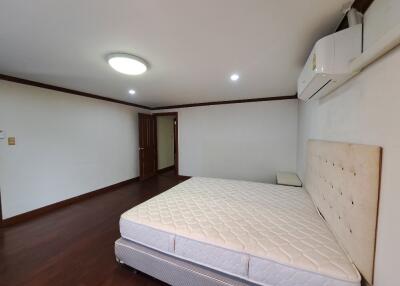 Spacious bedroom with bed and air conditioning